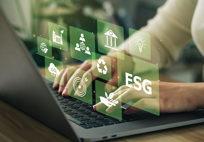 Hände tippen auf einer Tastatur, umgeben von ESG-Symbolen, vermittelt Engagement für Nachhaltigkeit und Verantwortung.